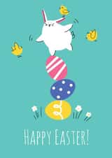 Cute easter greeting card with bunny balancing on painted eggs created by Nastea Fedorenko