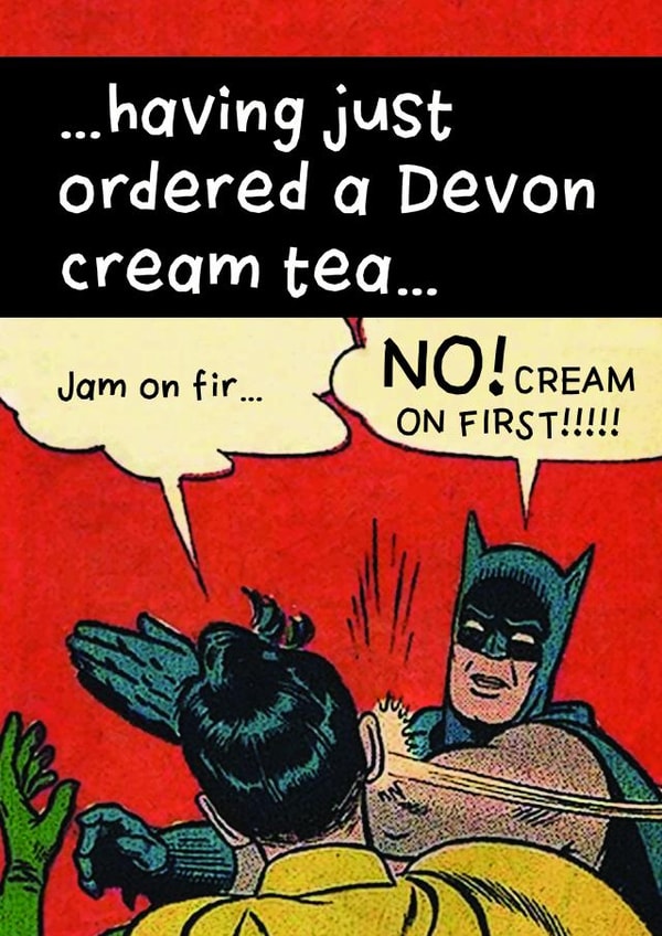 Batman and Robin having a Devon cream tea created by devoncow graphic design